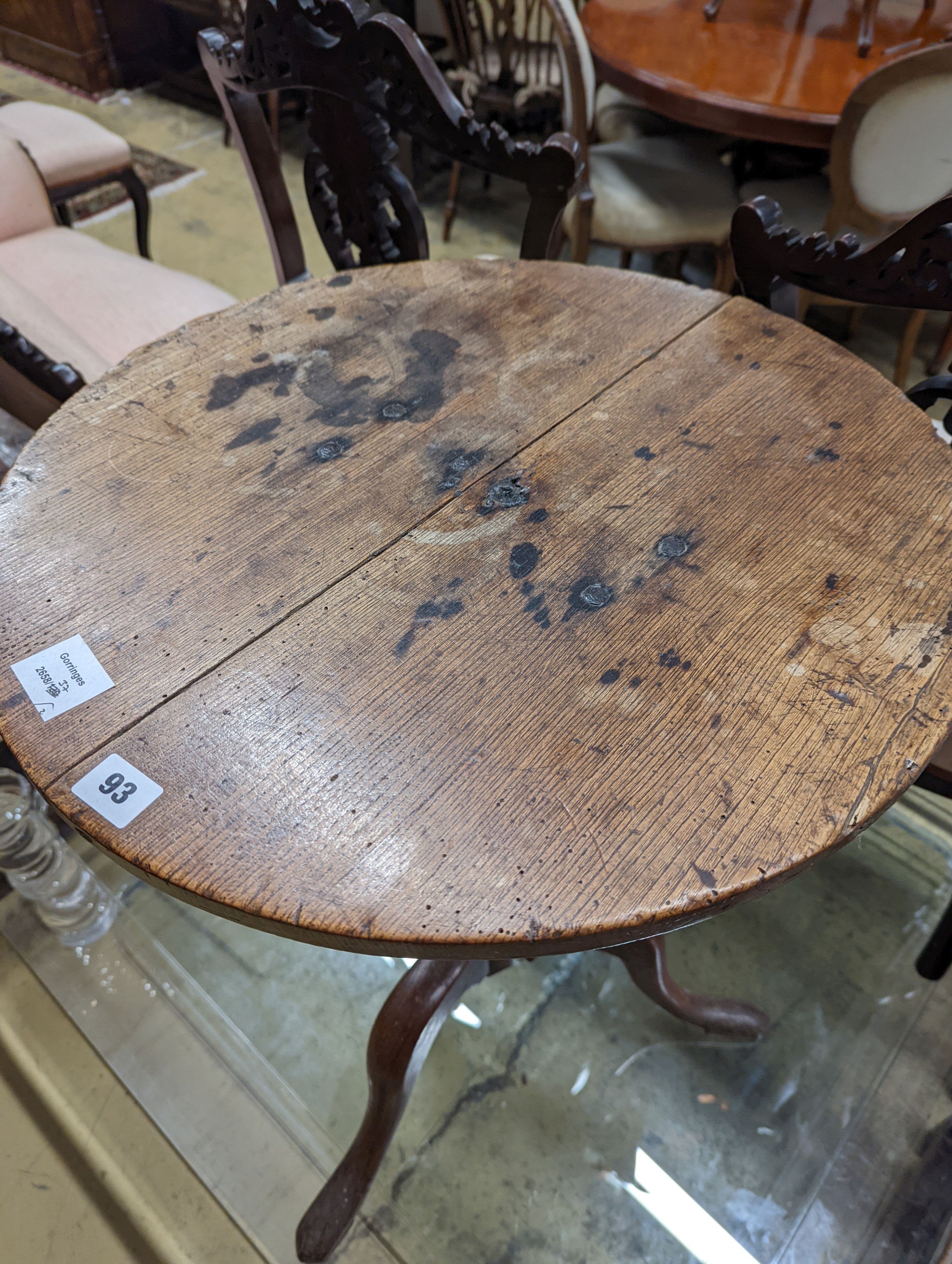 A 19th century oak stool and an oak tripod table, table diameter 53cm, 70cm height